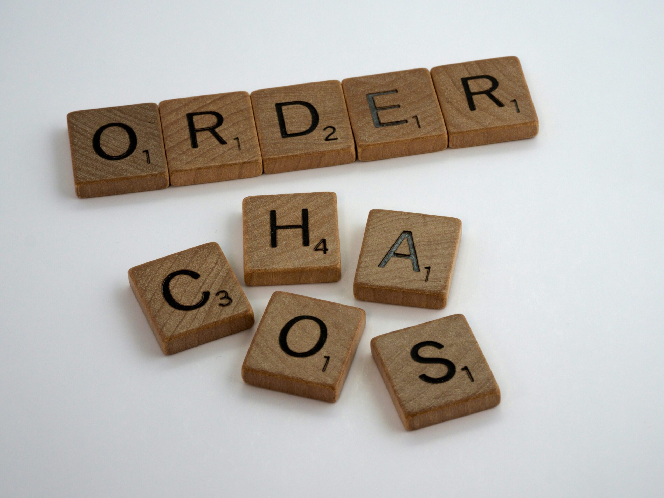 Scraccble tiles with the words order in a line and the word chaos all higgilty-piggilty